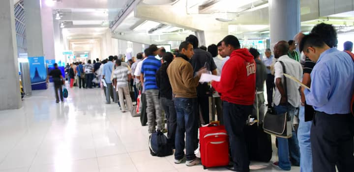 Line of people queueing at an airport