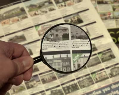 house and magnifying glass