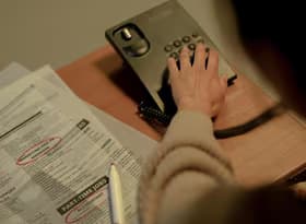 Rear view on woman choosing number on phone