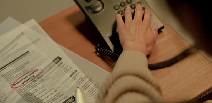 Rear view on woman choosing number on phone