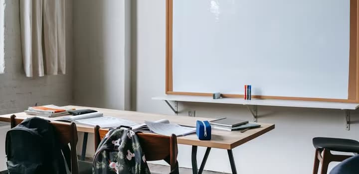 School bench with stationery in classroom