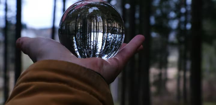 A person holding a crystal ball in their hand