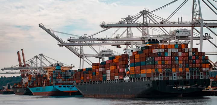 Cargo ships docked at the pier during day