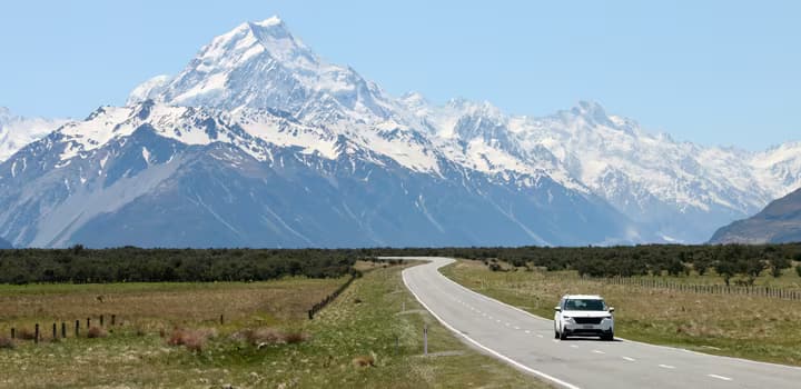 Car on road with Mount Cook in the background