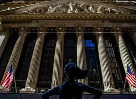 A statue of a woman standing in front of a building
