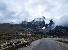 Road Curve in Front of Snowy Mountain