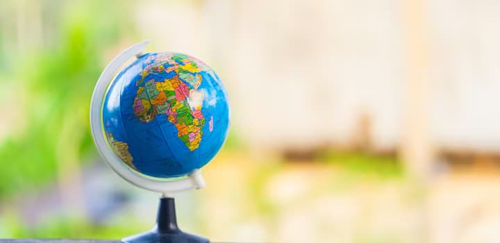 Colorful world globe on wooden surface