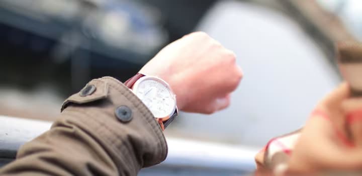 Selective Focus Photography of Person Watching Watch