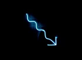 A blue neon sign on a black wall