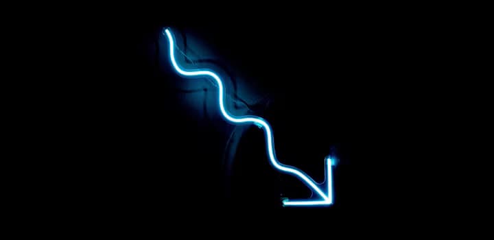 A blue neon sign on a black wall